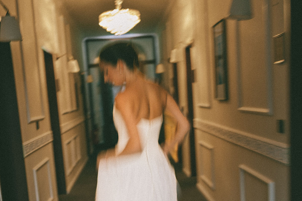 Bride in motion after her styling – an elegant wedding look created to remain natural throughout the wedding day.